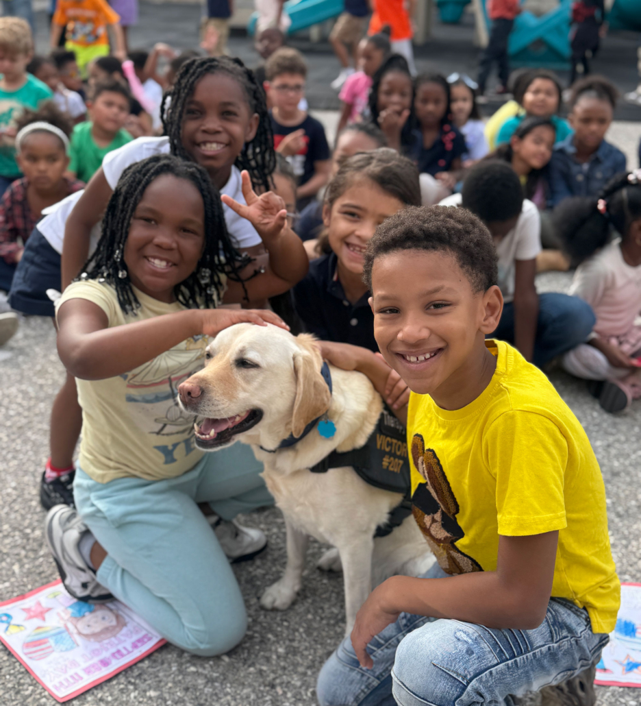 group-of-kids-with-dogs Group of Lincoln Charter School students petting a service dog.